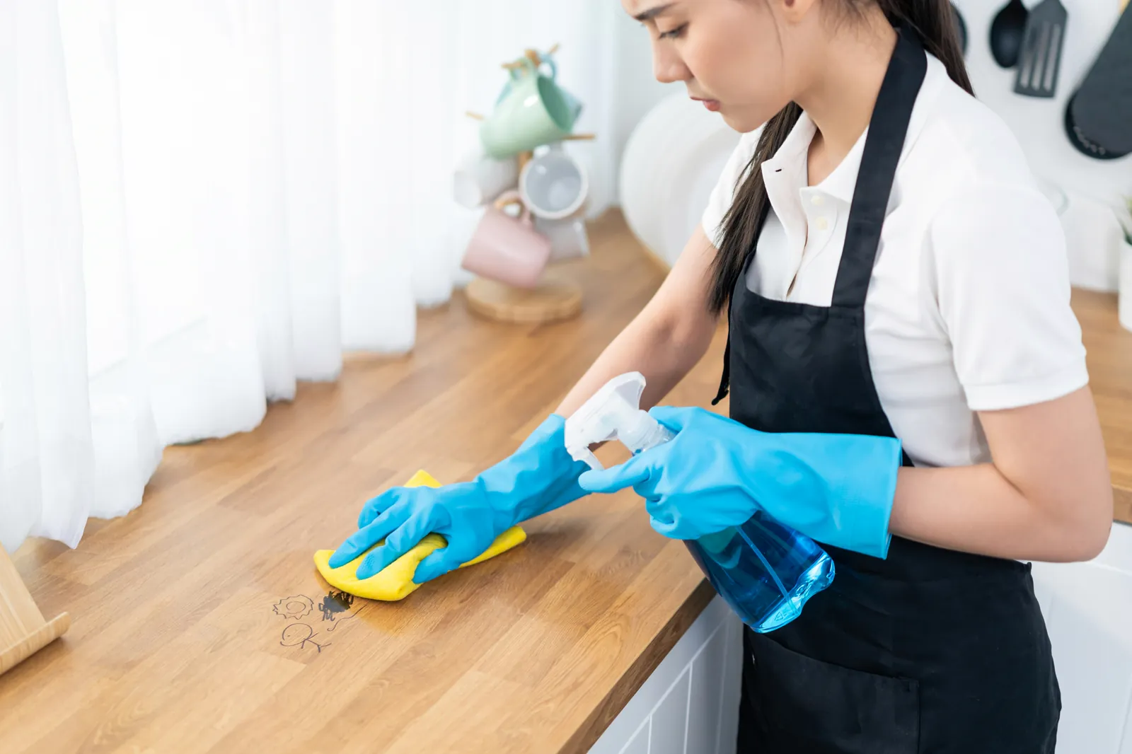 Housekeeper carrying out careful domestic work in a client's home